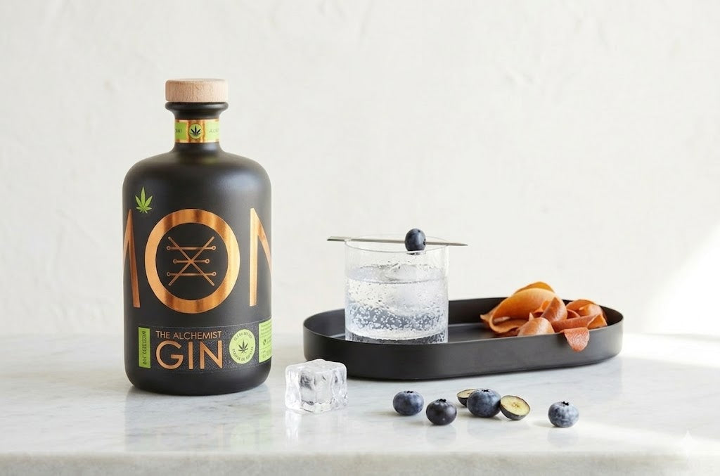 Bottle of 101 Gin with a glass of gin and tonic on a tray with fruit and a bottle opener.